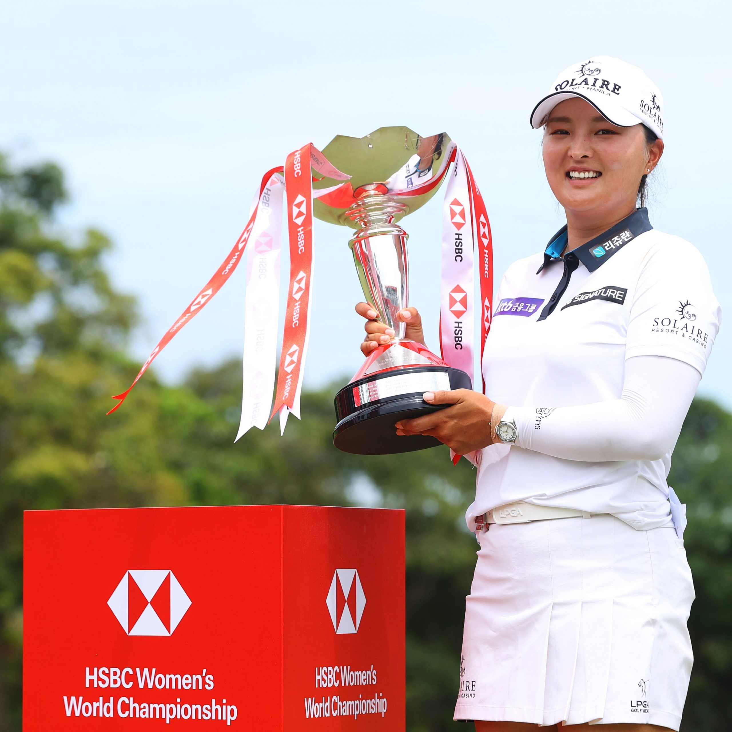 Jin Young Ko holding the champion trophy 2022